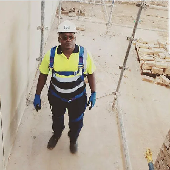 ATPGROUP HOLDINGS supervisor in safety harness inspecting a site under construction