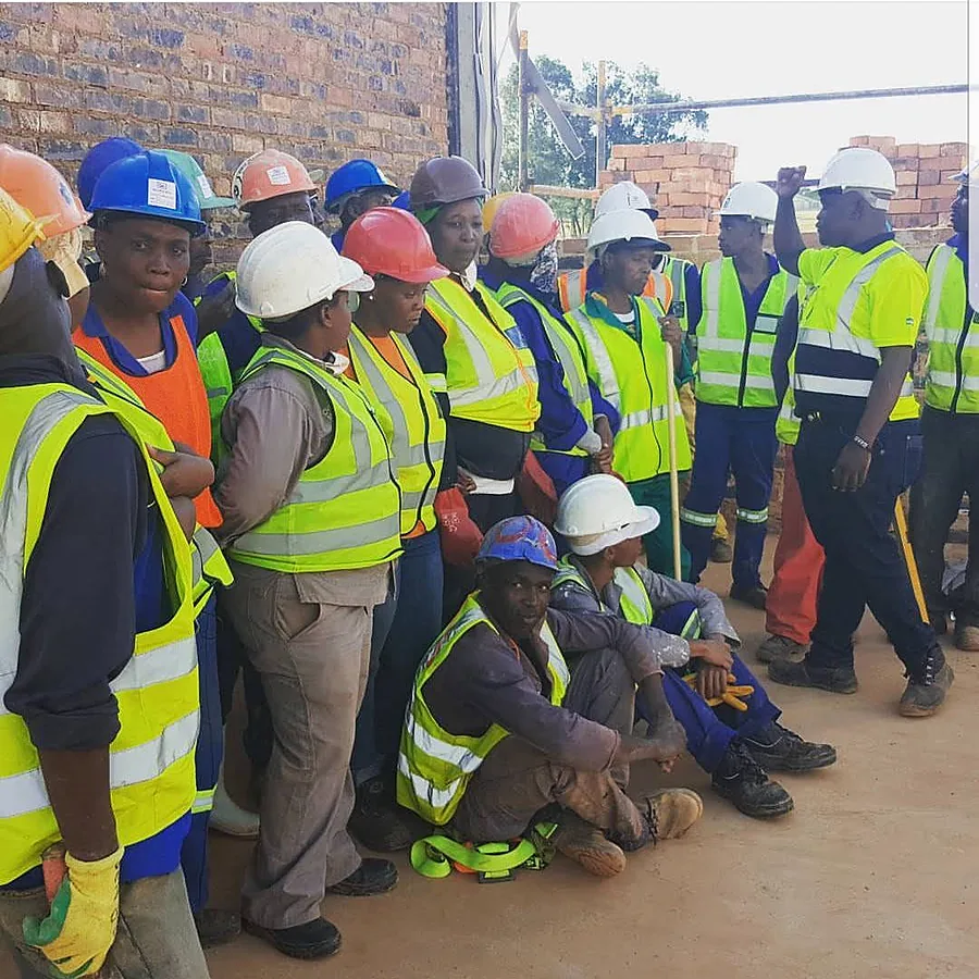 ATPGROUP HOLDINGS site team in hard hats and reflective vests on a construction site